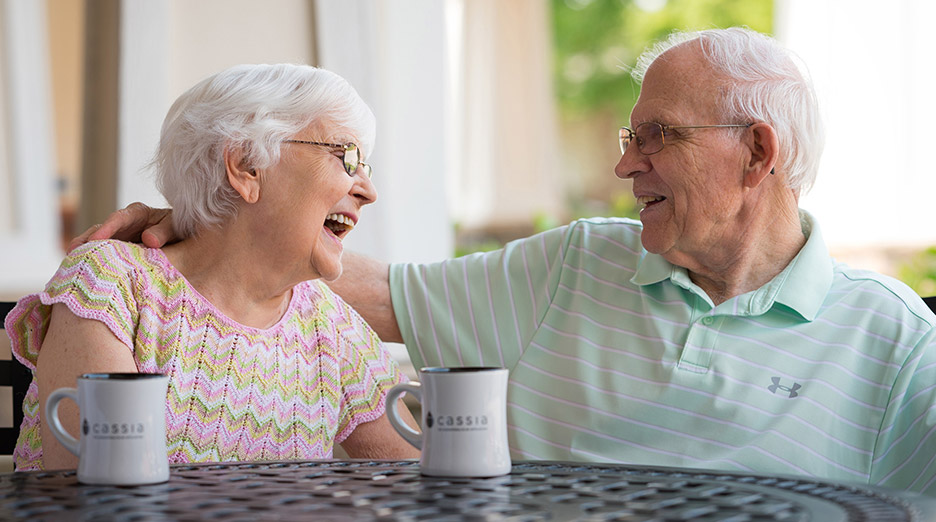 elderly couple having coffee