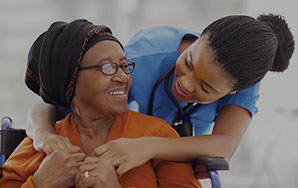 Caregiver providing personalized support to an older adult, representing long-term skilled nursing care at Moose Lake Village.
