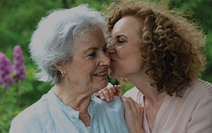 Older adult and family member spending time together, representing memory care services at Moose Lake Village.