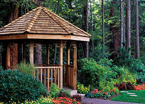 Gazebo surrounded by gardens and trees, representing outdoor spaces and walking paths at Moose Lake Village.