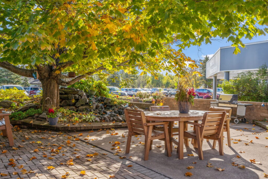 Outdoor patio and garden seating area at Moose Lake Village in Moose Lake, Minnesota.