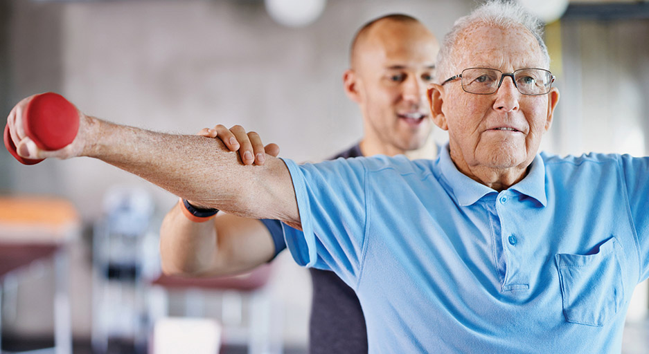 Older adult completing an upper-body exercise during rehabilitation therapy at Moose Lake Village.