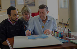 Older adults participating in an arts and crafts activity, representing resident activities at Moose Lake Village.