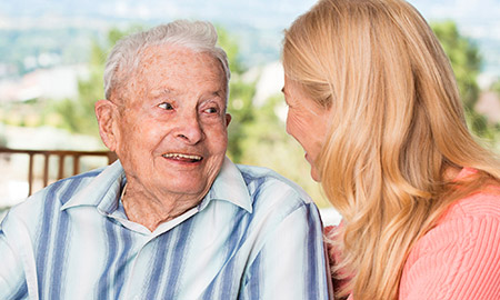 Older adult and visitor spending time together, representing personalized care and meaningful connections at Moose Lake Village.
