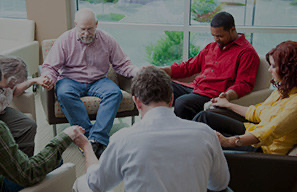 Group gathered in a circle for prayer or spiritual discussion, representing spiritual life programs at Moose Lake Village.